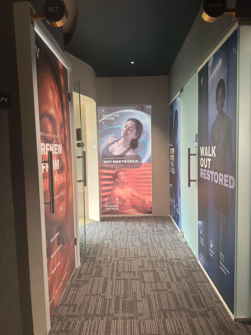 The therapy corridor at VAURA Wellness, HSR Layout, with cryotherapy, red light therapy and contrast therapy rooms